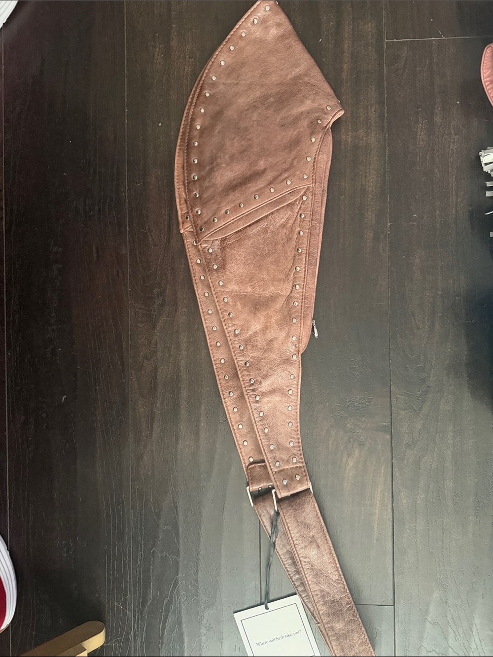 Brown Studded Bag: hold close to your body during travel or locally. Leather.